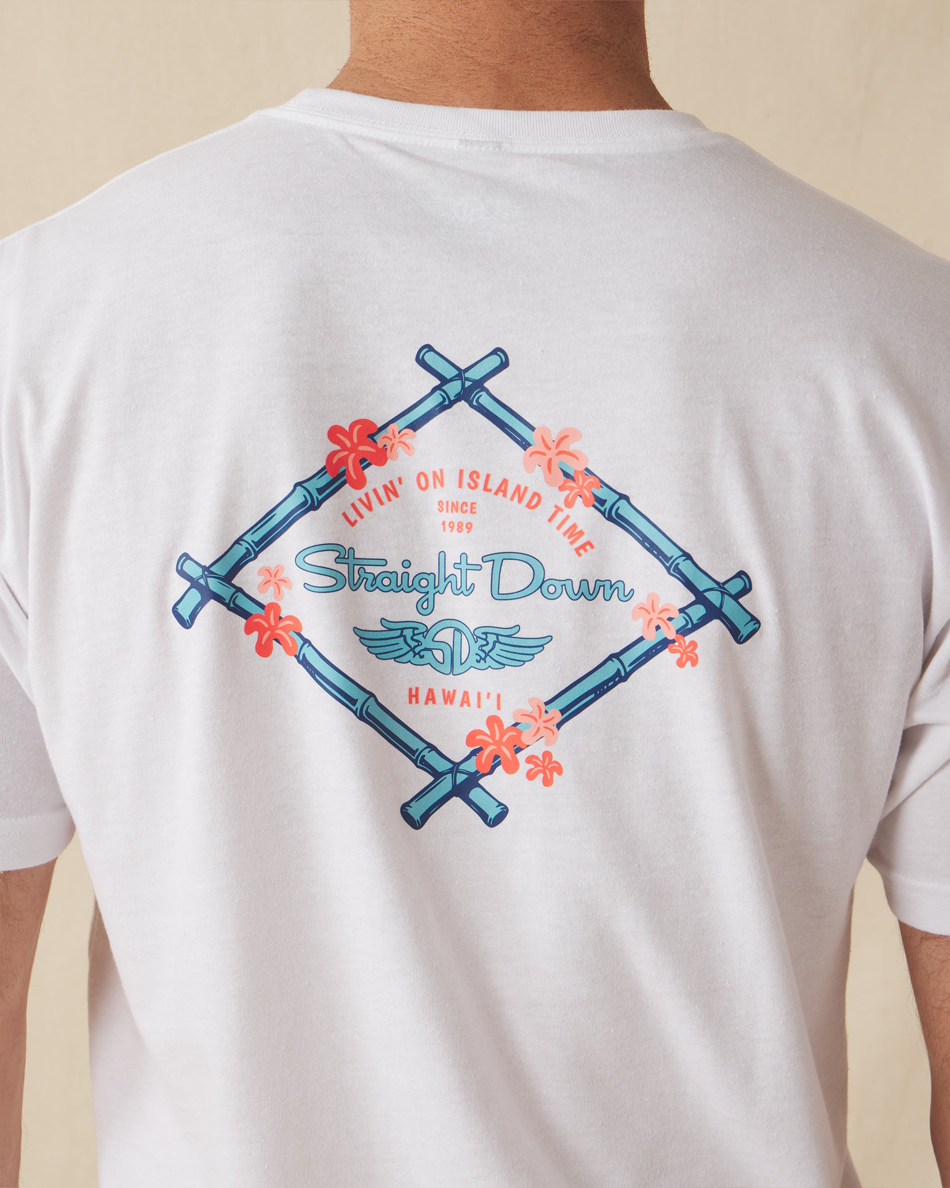 Men's Island Time Tee in White, close-up back detail view of the Straight Down Livin' On Island Time Hawai'i graphic with bamboo diamond frame and coral flowers