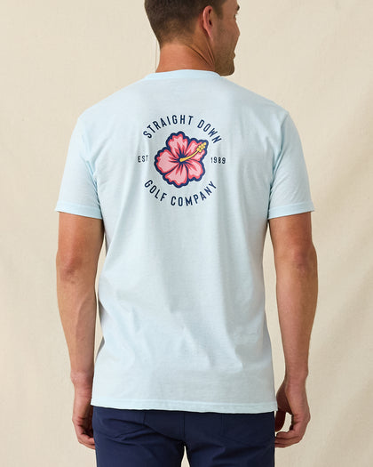Men's Hibiscus 89 Tee in Light Blue, back view on model featuring a large Straight Down Golf Company hibiscus graphic centered on the back, paired with navy pants