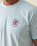 Men's Hibiscus 89 Tee in Light Blue, close-up front view on model featuring the Straight Down Golf Company hibiscus logo with "EST 1989" detail on the left chest