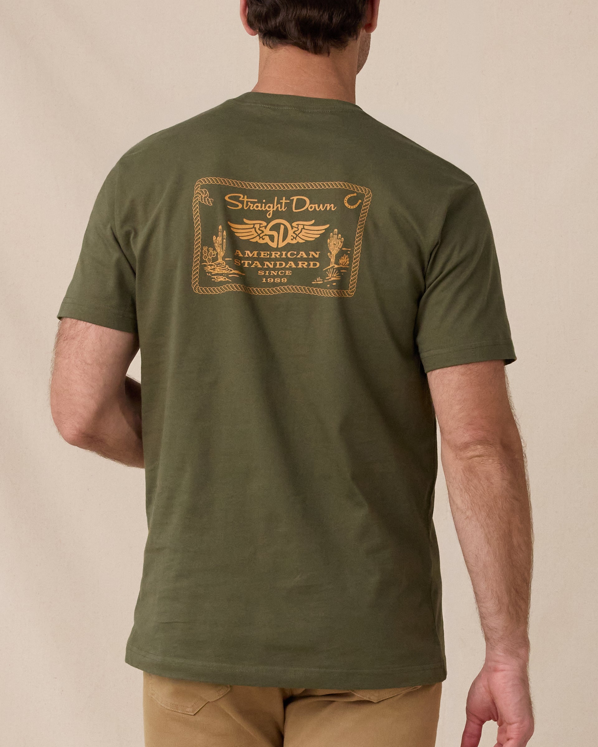 Back view of the American Standard Tee in Army Green featuring a large gold Straight Down American Standard graphic.