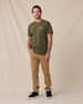 Man wearing the American Standard Tee in Army Green with tan pants and black sneakers.