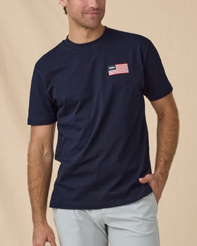 Free & Brave Tee in Navy, front model view with flag chest graphic
