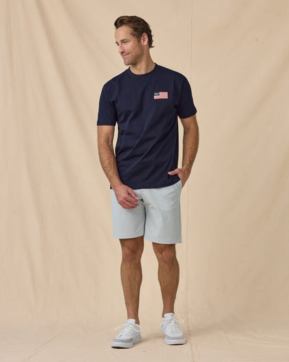 Free & Brave Tee in Navy, styled full outfit view with light shorts