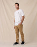 Man wearing the Old El Paso Tee in White with tan pants and black sneakers.
