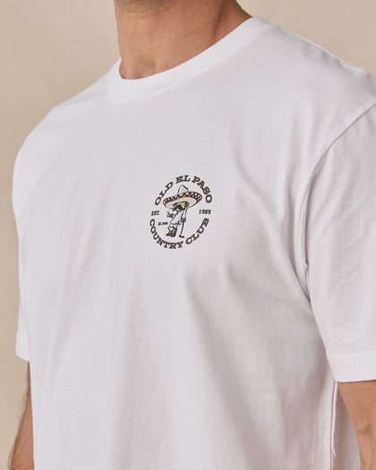Close-up of the Old El Paso Tee in White showing the small Old El Paso Country Club golfer graphic on the left chest.