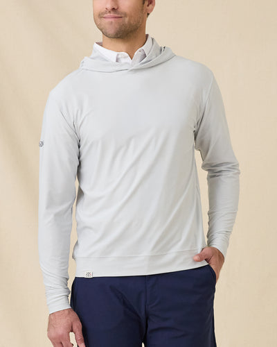 Model wearing the Hermosa Hoodie in Silver layered over a white polo