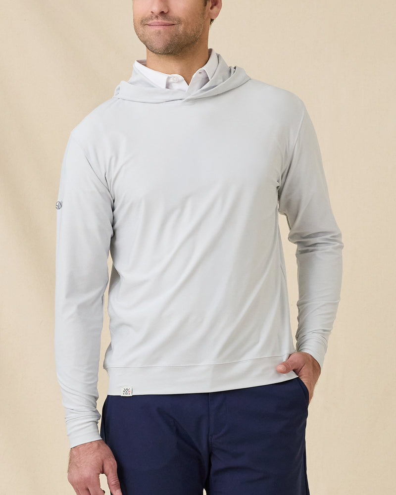 Model wearing the Hermosa Hoodie in Silver layered over a white polo