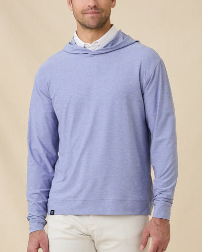 Model wearing the Hermosa Hoodie in Tidal Blue layered over a white polo