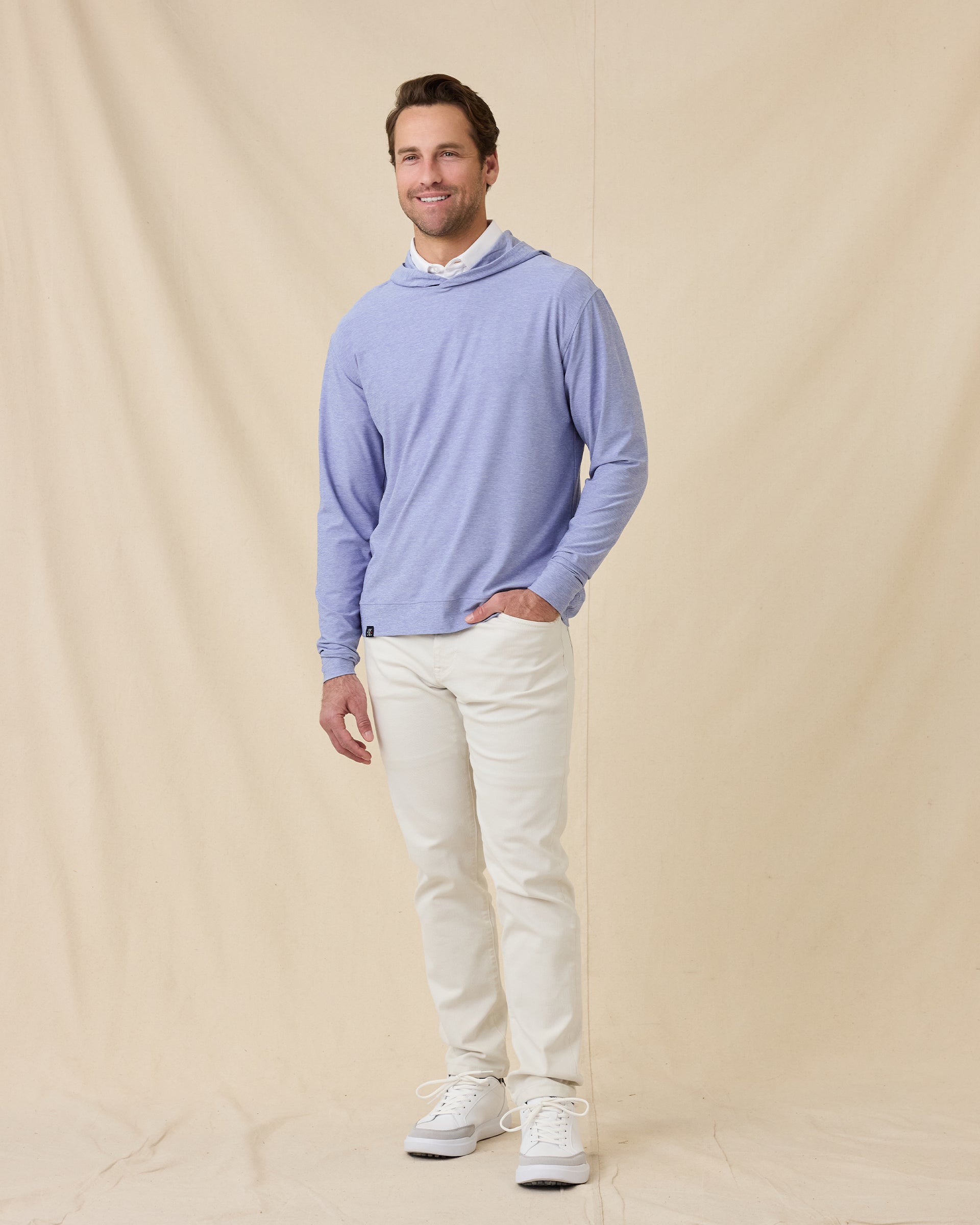 Model styled in the Hermosa Hoodie in Tidal Blue with white pants
