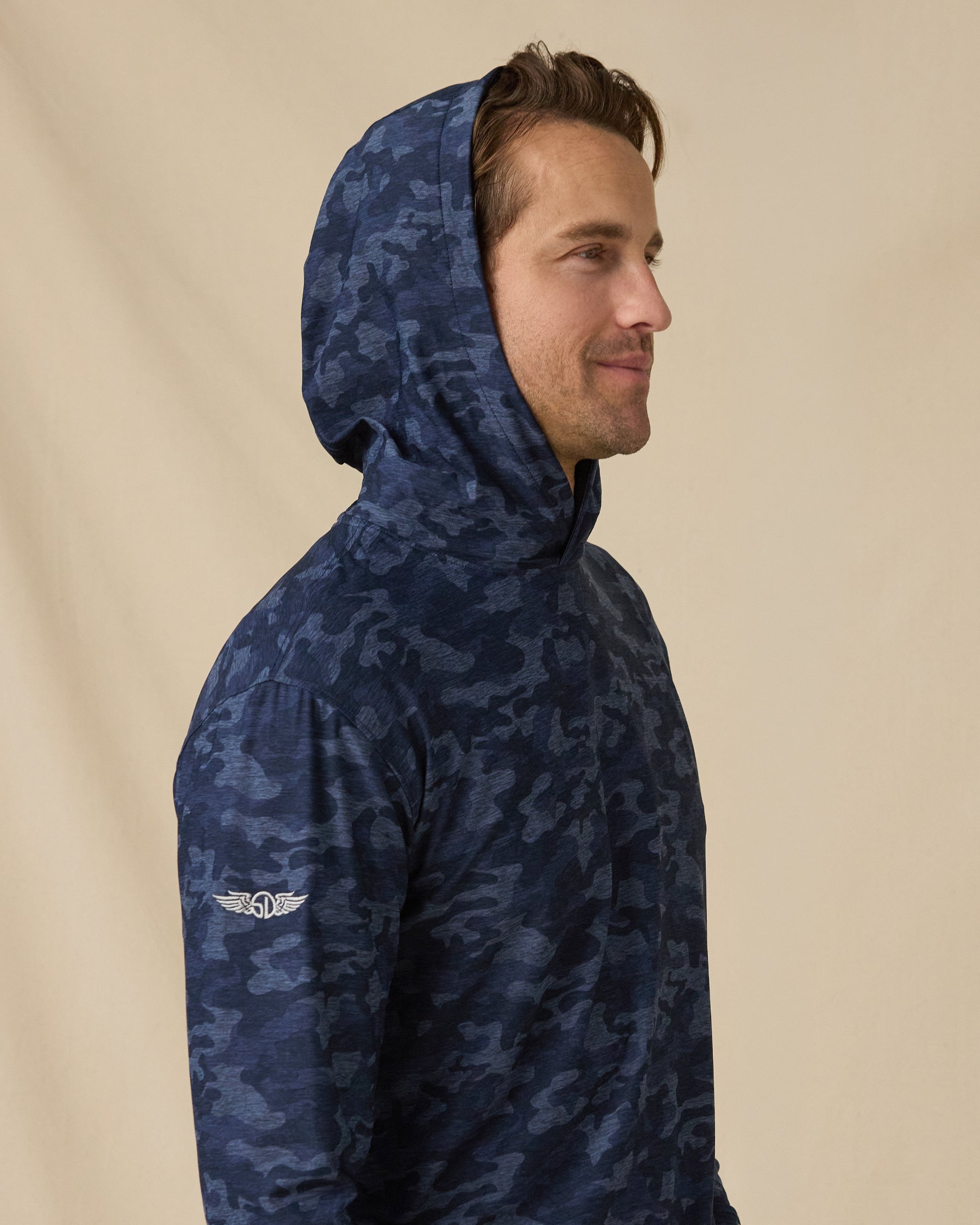 Men’s Commander Hoodie in New Indigo camouflage print with hood up, side profile view
