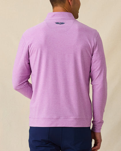 Back view of men’s heather pink quarter-zip pullover with subtle logo at neck, paired with navy pants.
