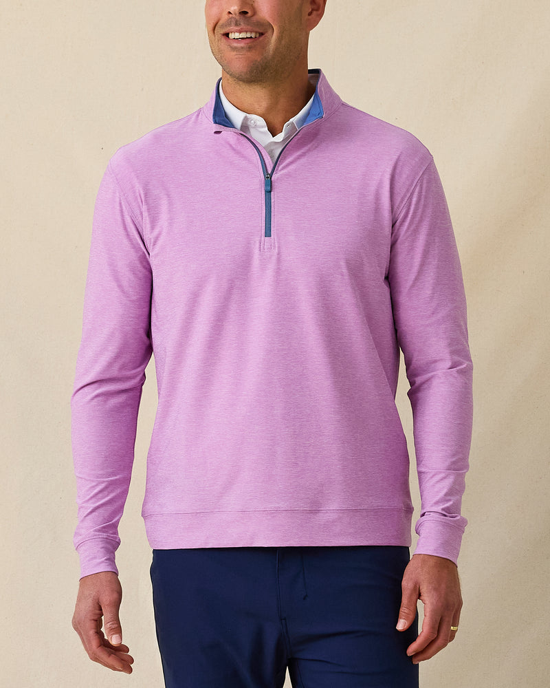 Men’s heather pink quarter-zip pullover with contrast blue inner collar, styled with navy pants.