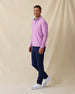 Men’s pink quarter-zip pullover styled with navy pants and white sneakers in a casual golf outfit.