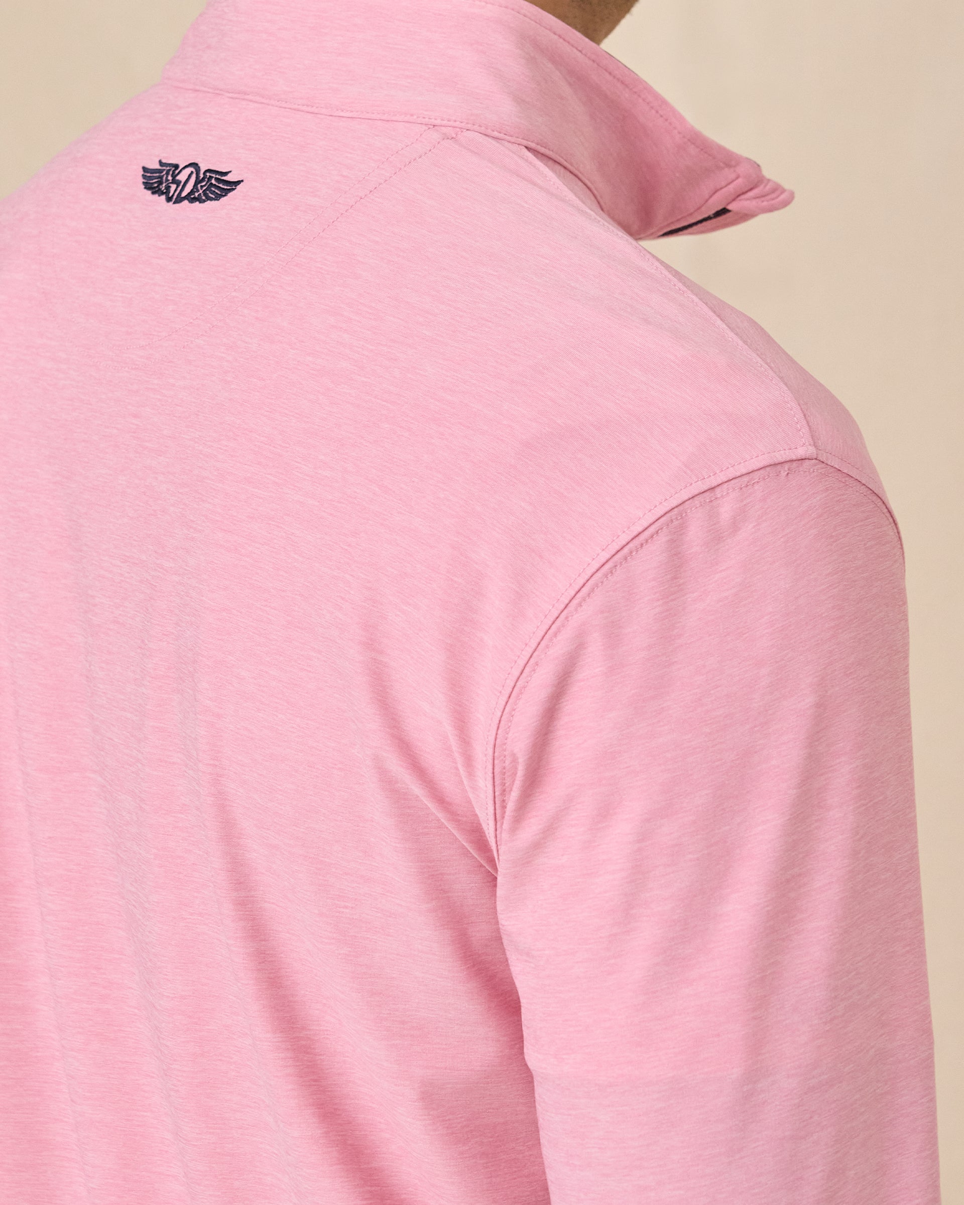 Close-up back view of the Oceanside 2.0 Quarter Zip in Punch Pink featuring the embroidered Straight Down logo below the collar