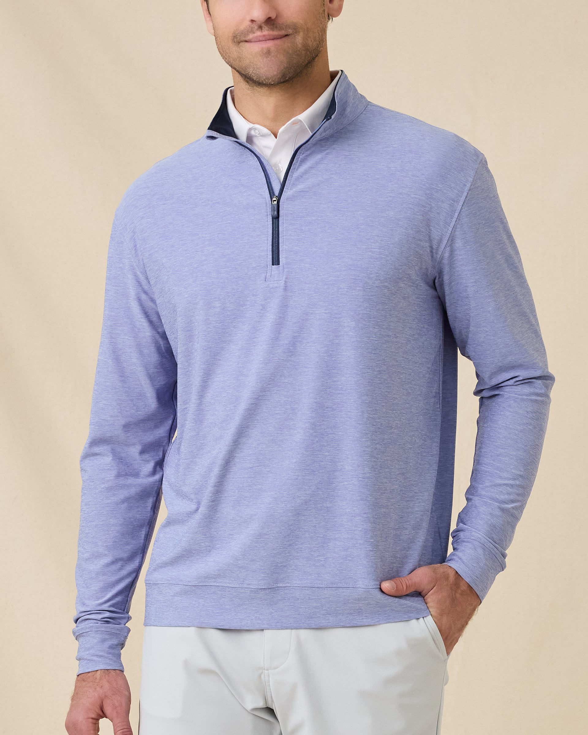Model wearing the Oceanside 2.0 Quarter Zip in Tidal Blue with a heathered performance fabric and contrast-lined collar
