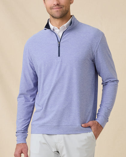 Model wearing the Oceanside 2.0 Quarter Zip in Tidal Blue with a heathered performance fabric and contrast-lined collar