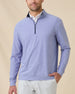 Model wearing the Oceanside 2.0 Quarter Zip in Tidal Blue with a heathered performance fabric and contrast-lined collar