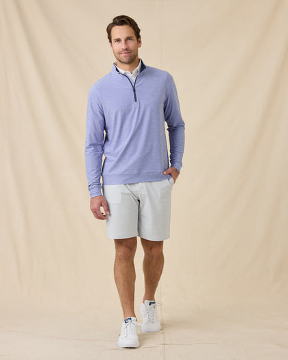 Model wearing the Oceanside 2.0 Quarter Zip in Tidal Blue with light gray golf shorts