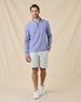 Model wearing the Oceanside 2.0 Quarter Zip in Tidal Blue with light gray golf shorts