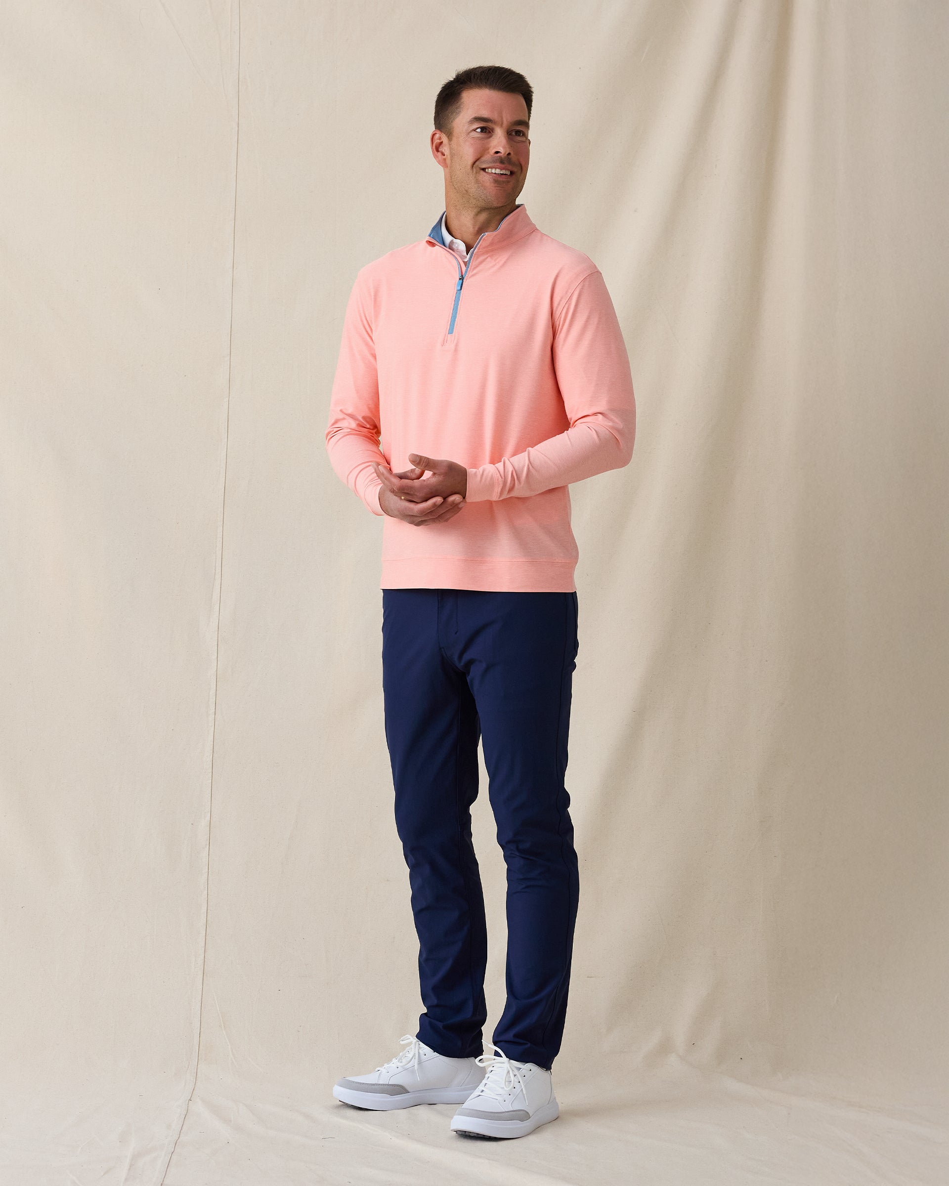 Oceanside 2.0 Quarter Zip in spritz orange, full outfit styled with navy pants 