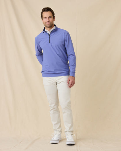 Model styled in the Bel Air Quarter Zip in Tidal Blue, white performance pants