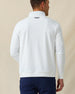 Back view of men’s white textured quarter-zip pullover with subtle embroidered logo at the neck, paired with navy pants.