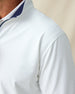 Close-up of white quarter-zip pullover showing subtle textured performance fabric and stitching detail.