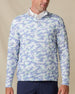 Model wearing the Arlington Quarter Zip in Blue Shade, featuring a soft blue and mint camouflage print with a quarter-zip neckline.