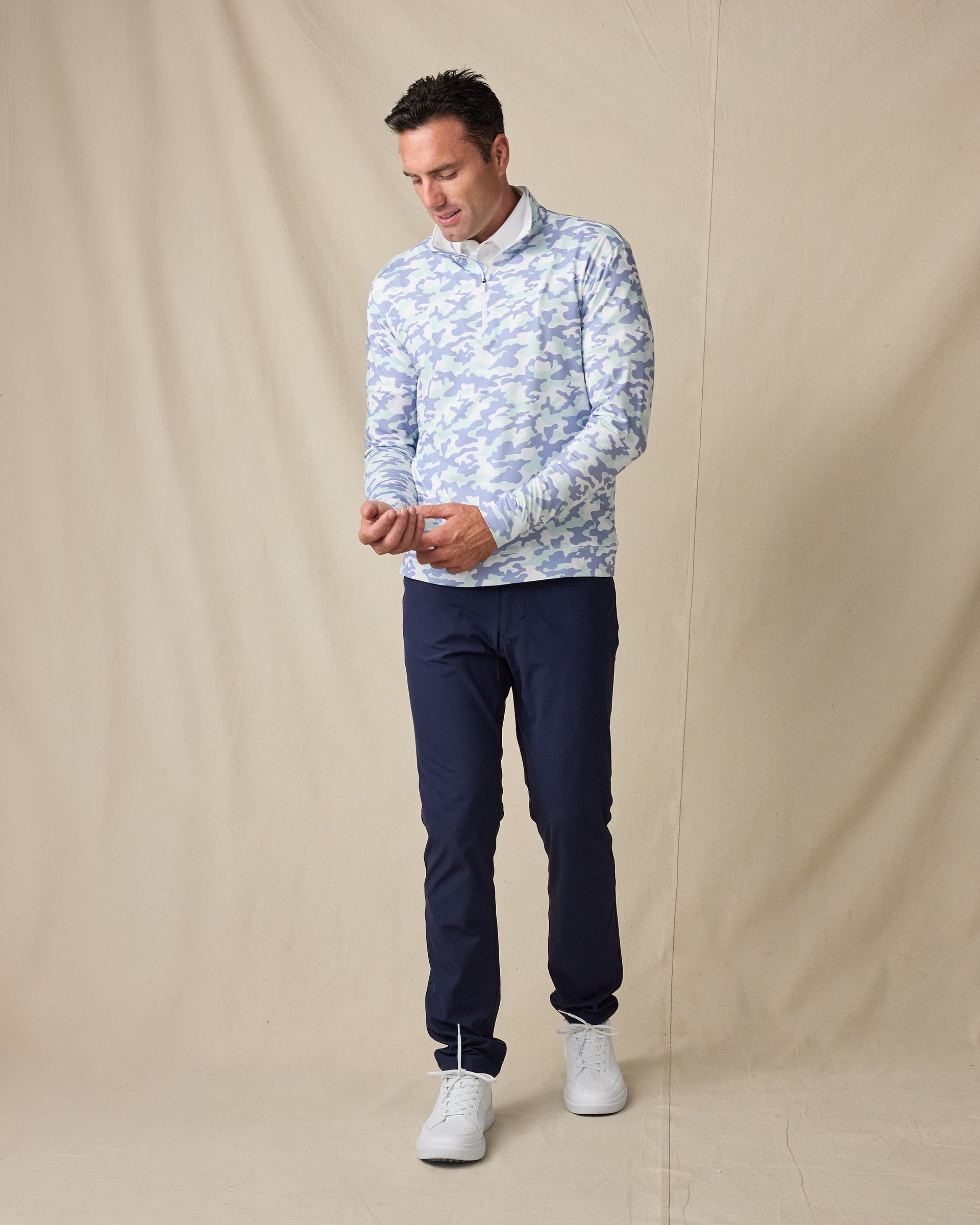 Model wearing the Arlington Quarter Zip in Blue Shade with navy pants and white sneakers.