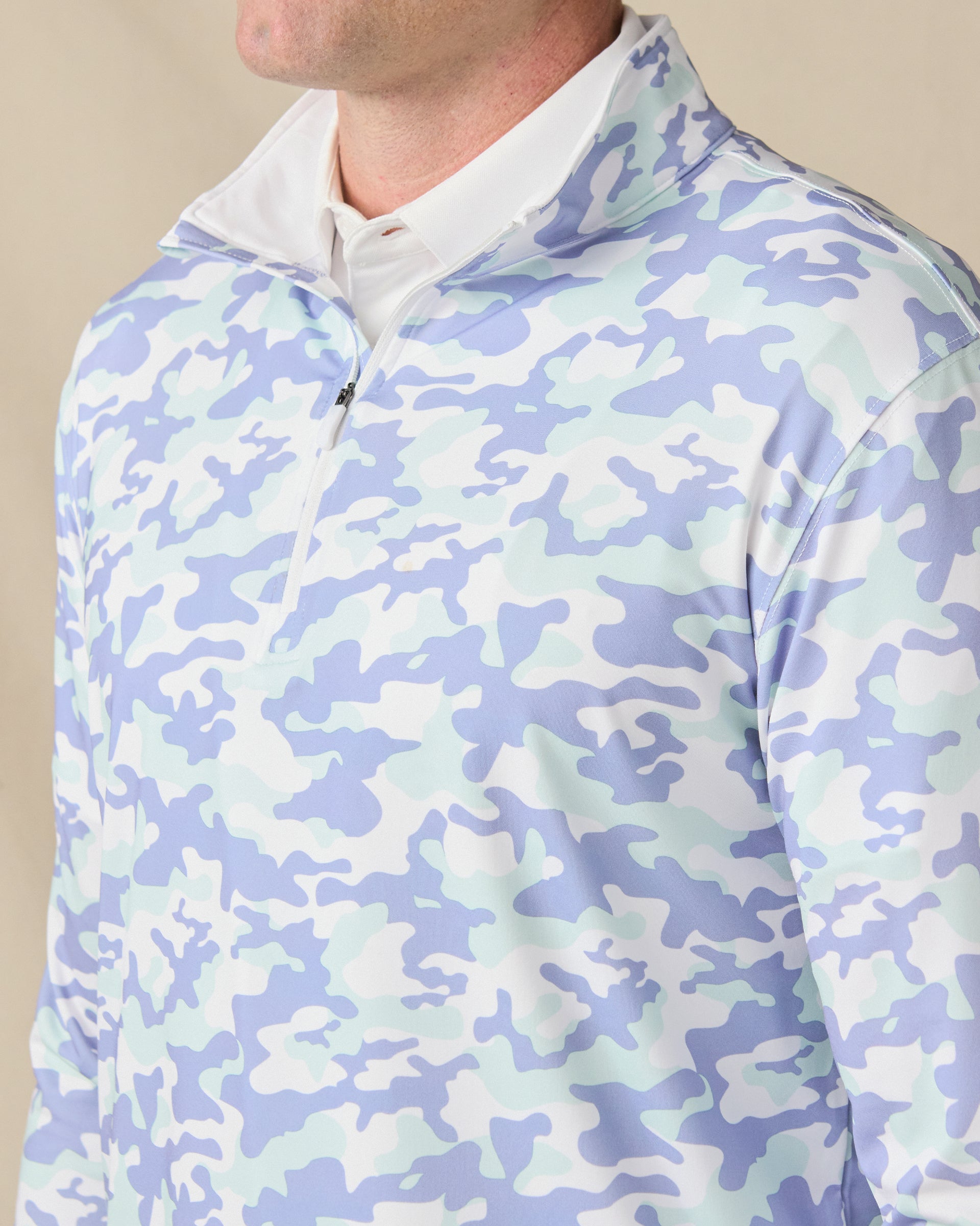 Close-up of the Arlington Quarter Zip in Blue Shade, featuring a soft blue, mint, and white camouflage print with a quarter-zip neckline.