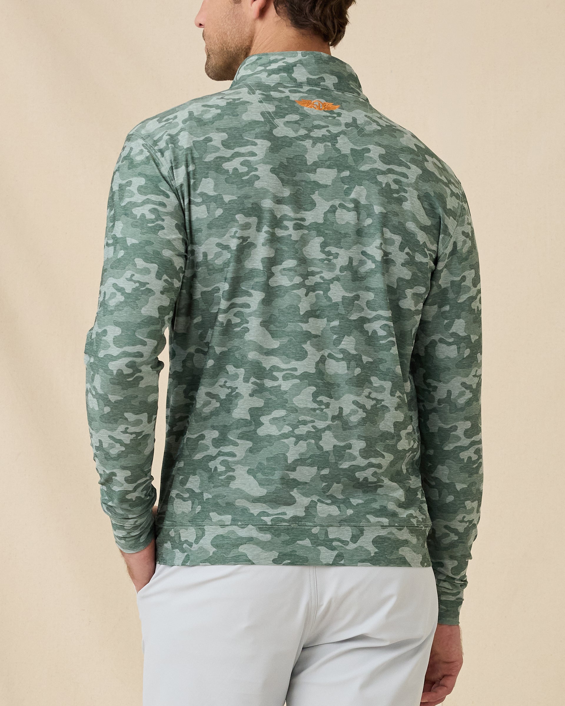 Back view of the Arlington Quarter Zip in Dark Forest showing the camouflage print and orange embroidered logo below the collar.