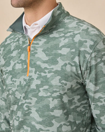 Close-up of the Arlington Quarter Zip in Dark Forest highlighting the camouflage print, stand collar, and contrasting orange zipper.
