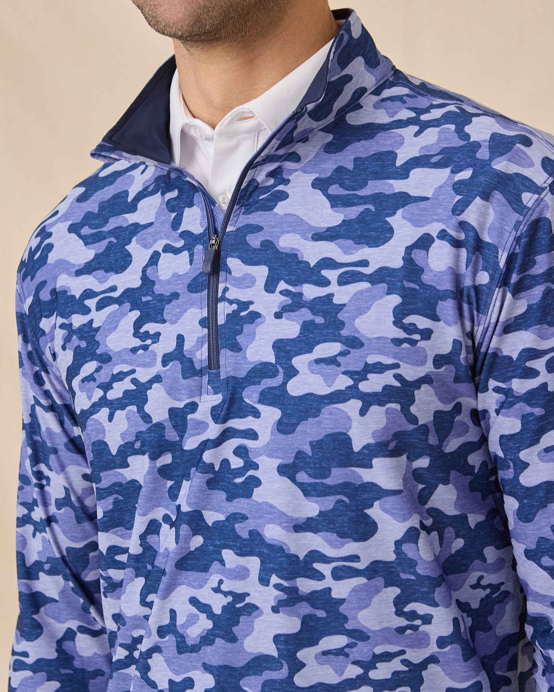 Close-up of the Arlington Quarter Zip in Tidal Blue featuring the blue camo print, quarter-zip closure, and contrast interior collar