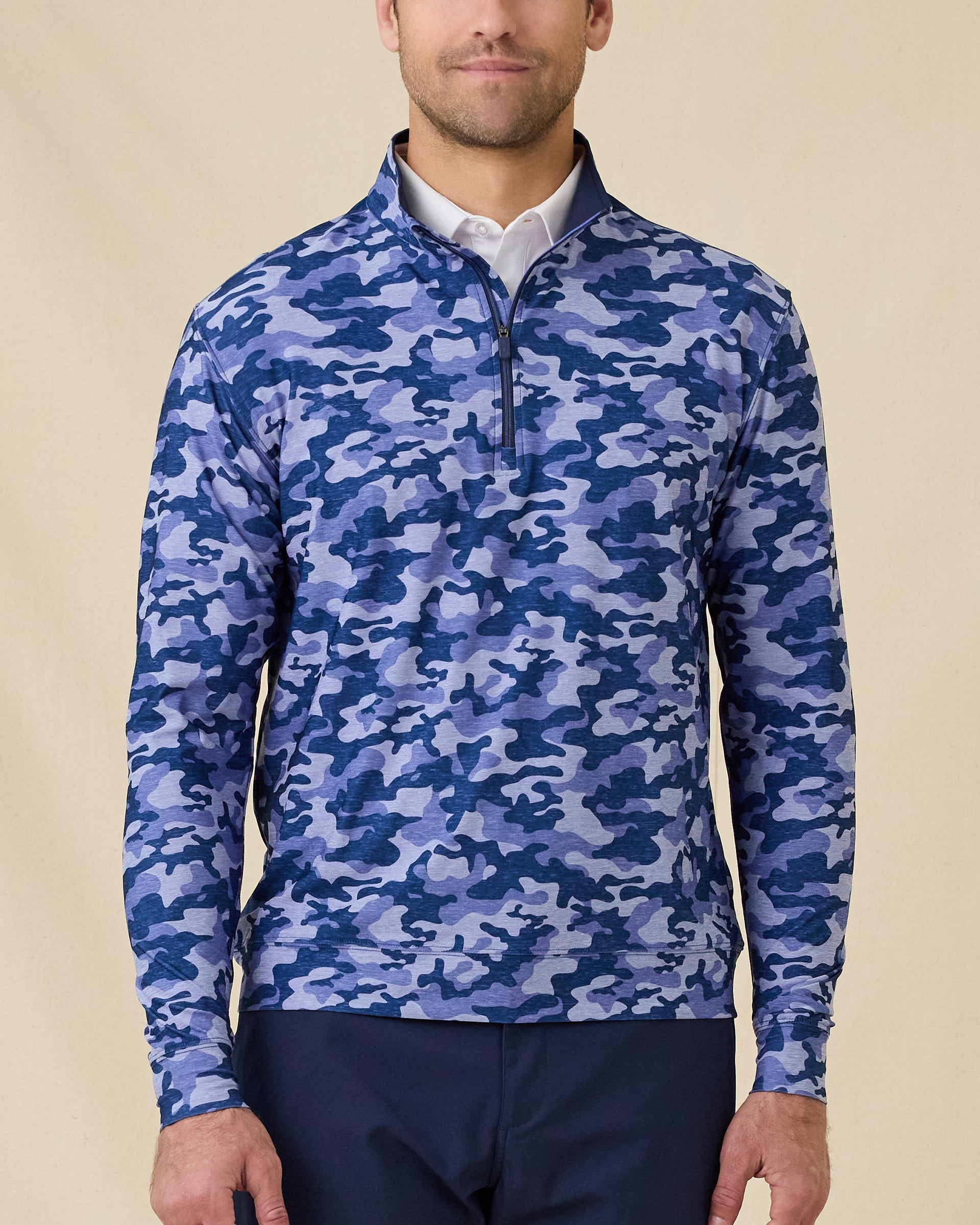 Model wearing the Arlington Quarter Zip in Tidal Blue with a blue camo print