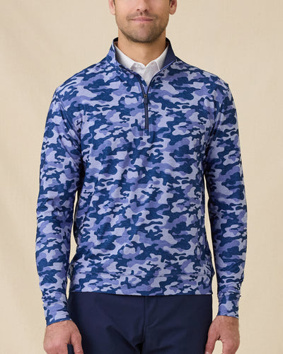 Model wearing the Arlington Quarter Zip in Tidal Blue with a blue camo print