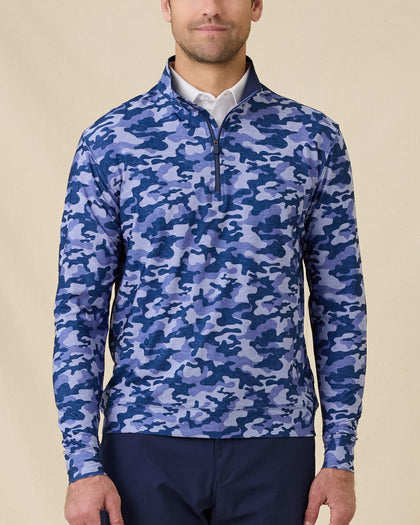 Model wearing the Arlington Quarter Zip in Tidal Blue with a blue camo print