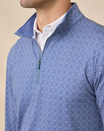 Close-up of the Mulholland Quarter Zip in Moonlight showing the geometric print, quarter-zip closure, zipper pull, and contrast blue inner collar.