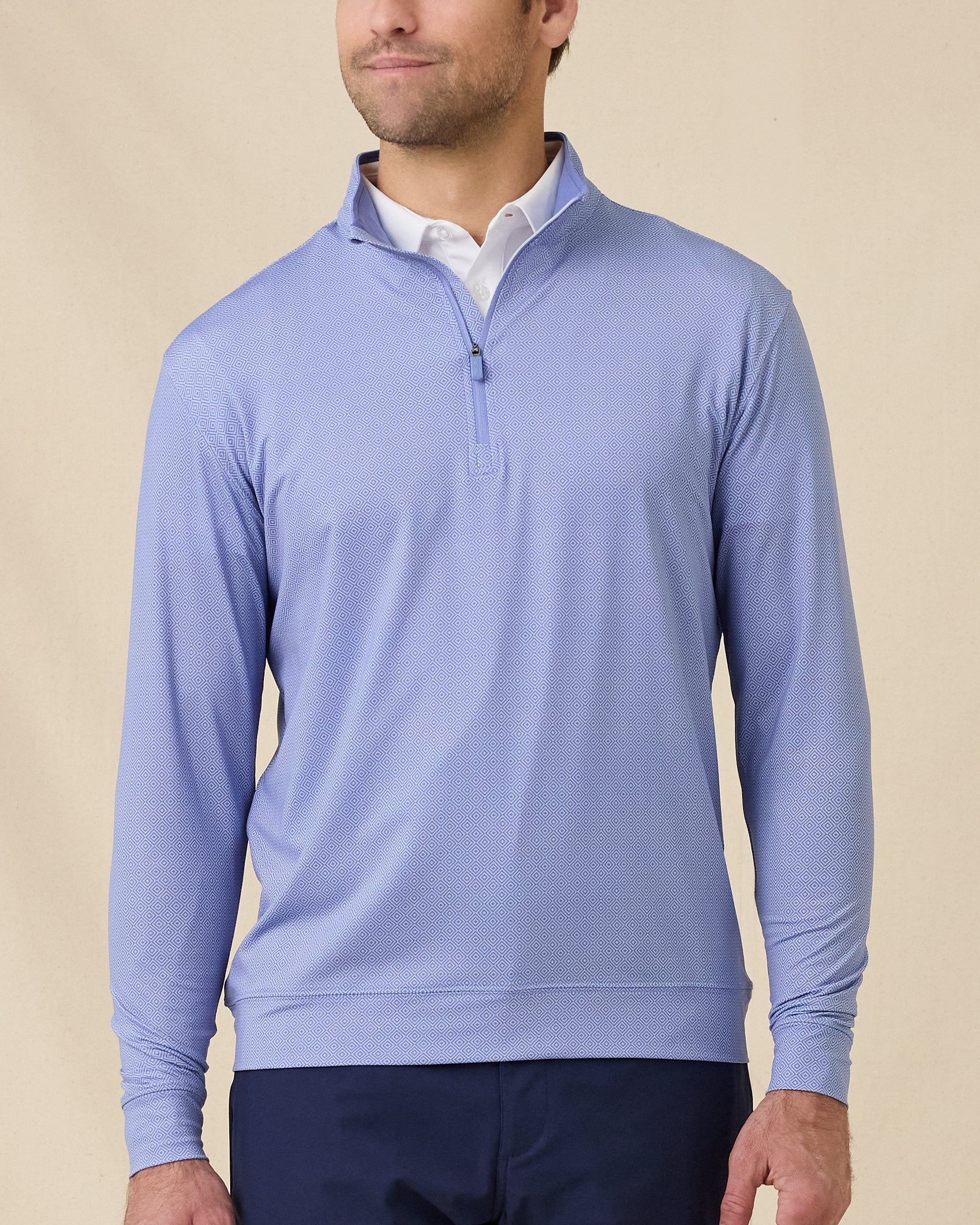 Model wearing the San Marino Quarter Zip in Tidal Blue with an all-over geometric pattern