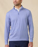 Model wearing the San Marino Quarter Zip in Tidal Blue with an all-over geometric pattern