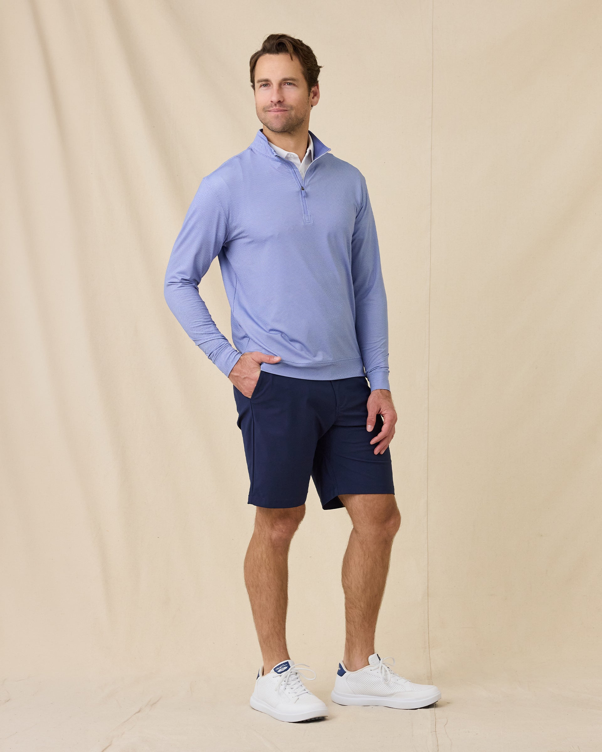 Model wearing the San Marino Quarter Zip in Tidal Blue paired with navy shorts