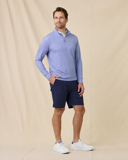 Model wearing the San Marino Quarter Zip in Tidal Blue paired with navy shorts