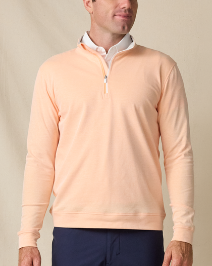 Model wearing the Glendale Quarter Zip in Cantaloupe, featuring a clean quarter-zip neckline and lightweight layering design.
