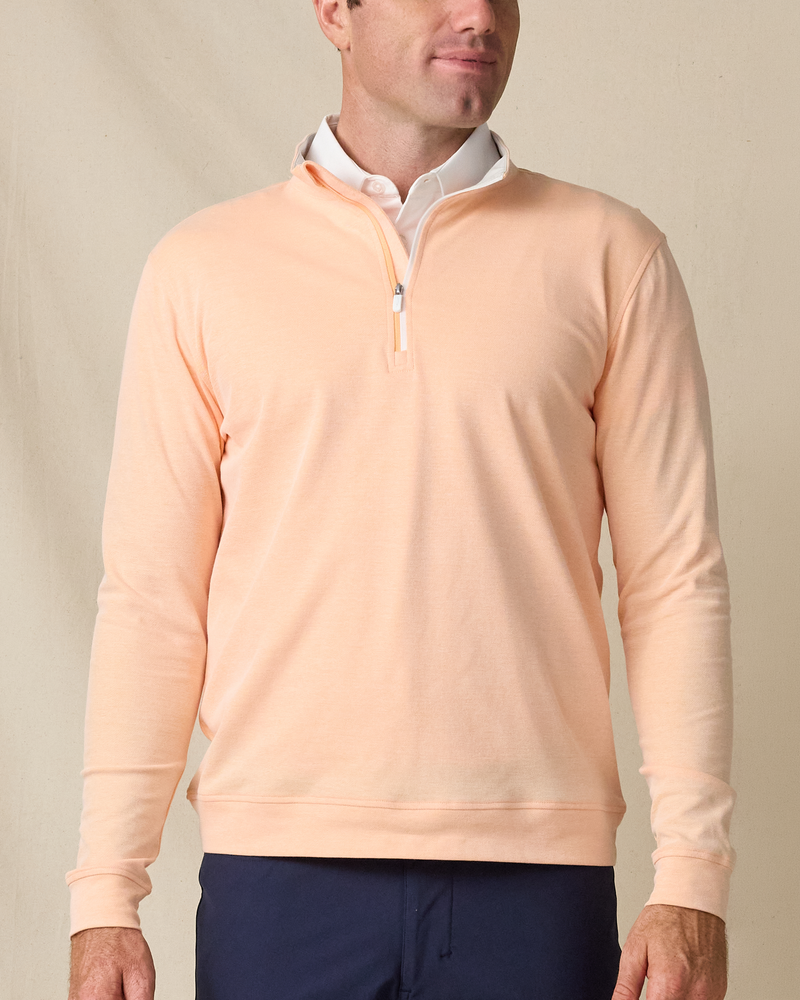 Model wearing the Glendale Quarter Zip in Cantaloupe, featuring a clean quarter-zip neckline and lightweight layering design.