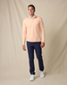 Model wearing the Glendale Quarter Zip in Cantaloupe with navy pants and white sneakers.