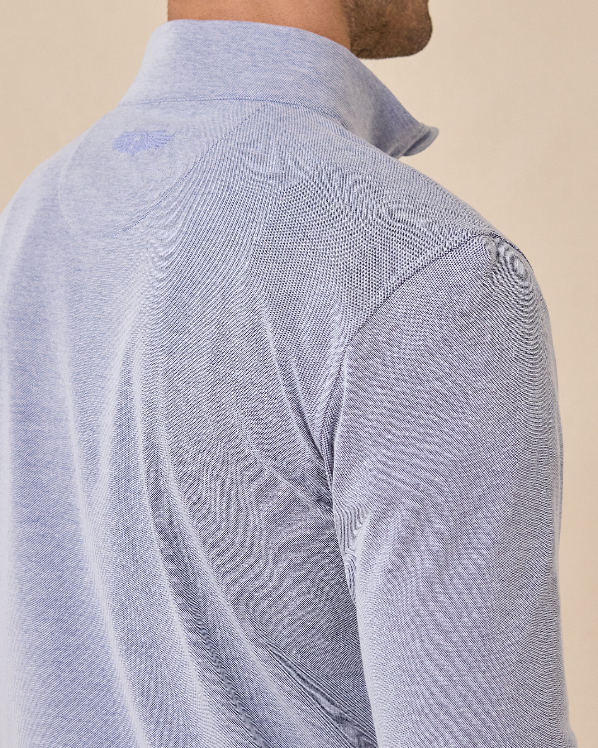 Close-up back view of the Glendale Quarter Zip in Tidal Blue featuring the tonal Straight Down logo below the collar
