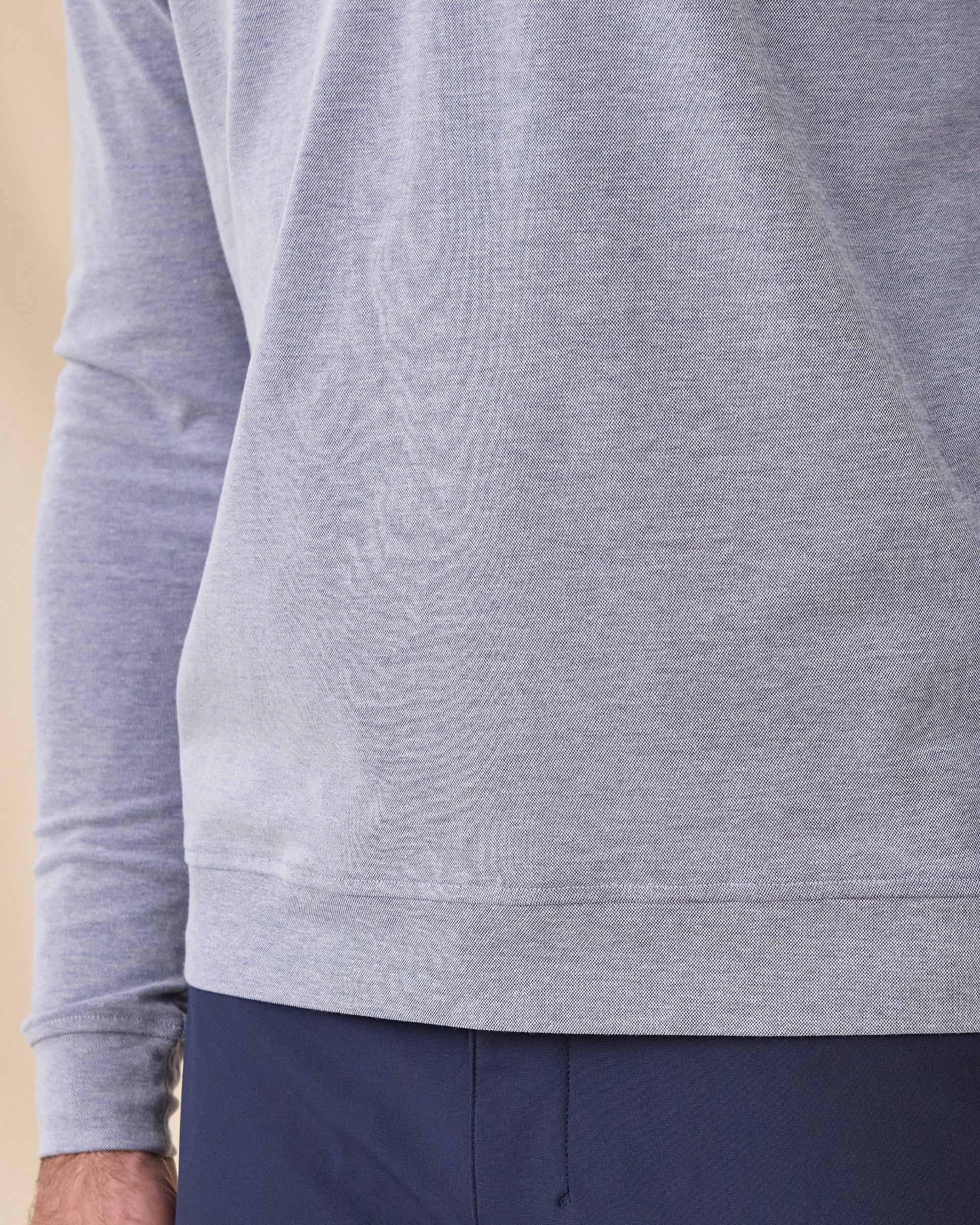 Close-up of the Glendale Quarter Zip in Tidal Blue highlighting the lightweight oxford pique texture and ribbed hem