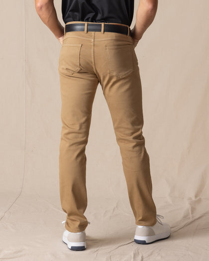 Men's Claremont Five Pocket Twill Pant in British Khaki, back on-model view featuring two patch pockets in warm tan twill fabric, styled with a black t-shirt, black leather belt, and white shoes