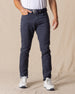Men's Claremont Five Pocket Twill Pant in Ink, front on-model view featuring a dark navy twill fabric, styled with a white t-shirt, navy leather belt, and white shoes