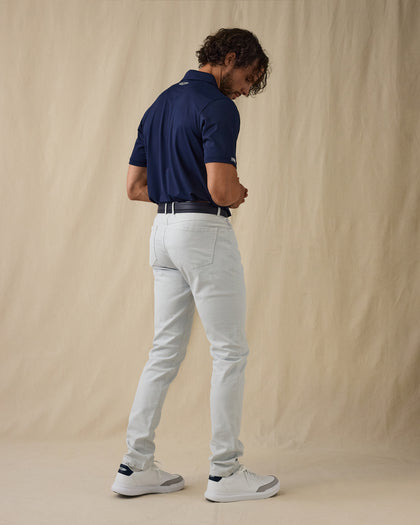 Men's Claremont Five Pocket Twill Pant in Silver, side on-model view featuring a light gray twill fabric, styled with a navy polo, navy leather belt, and white shoes