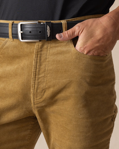 Men's Smithson Corduroy Pant in Bronze, close-up detail view of the front pocket and waistband featuring fine wale corduroy texture, styled with a black leather belt with silver buckle